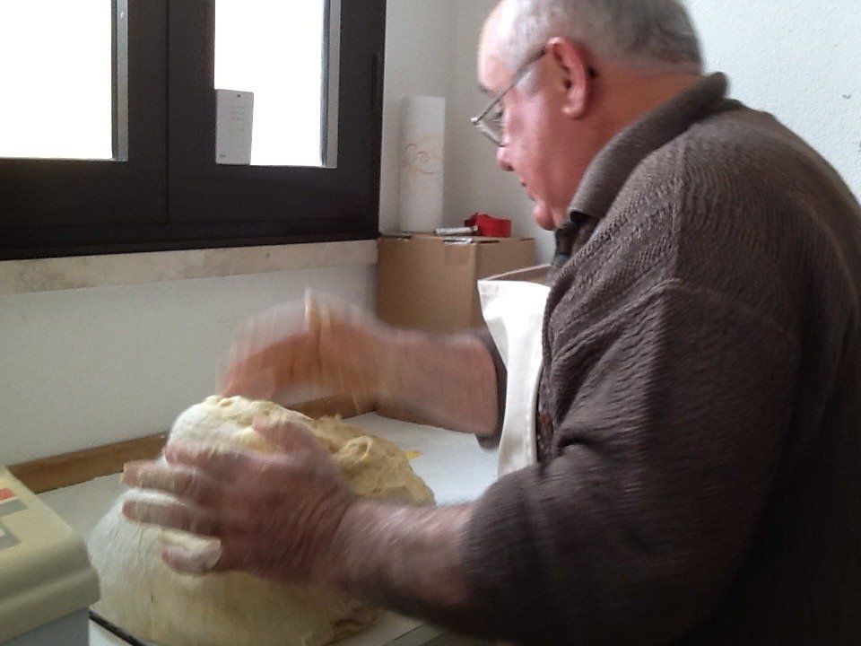 My father-in-law kneading the mass of dough expertly